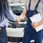 husband car mechanic and woman customer make an agreement on the repair of the car